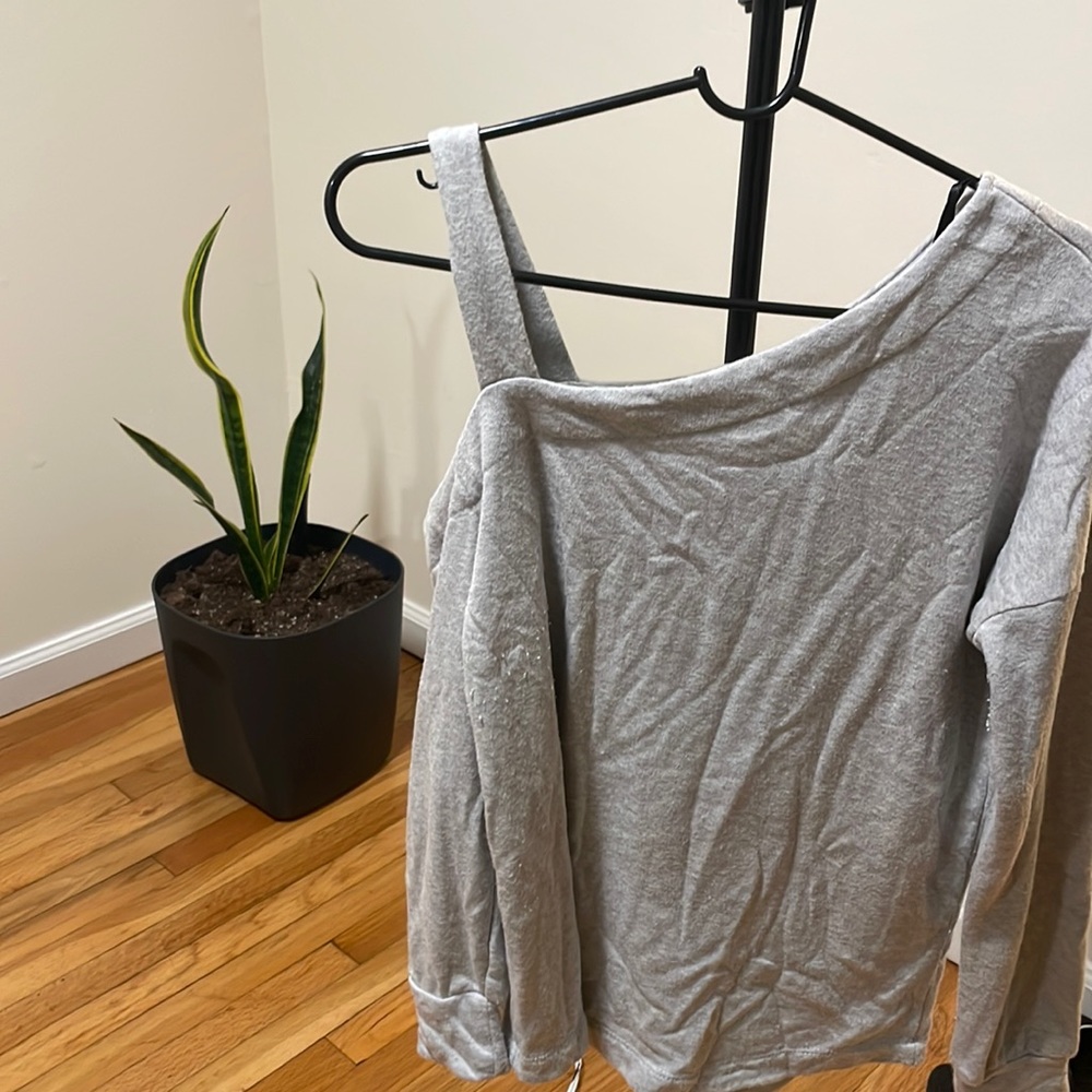 Half Shoulder off gray sweater.